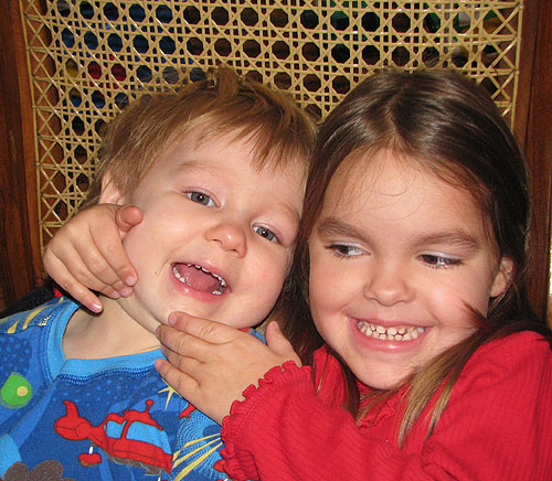 a rare moment of sibling giggling in the Nica rocking chair