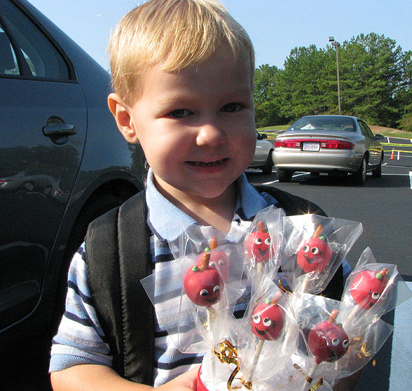 A sweet smile outside, holding the cute (and tasty!) apple-shaped cake pops we gave his teacher, Miss Kaylor.