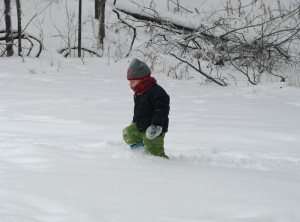 Josiah walks through the snow near the sledding hill