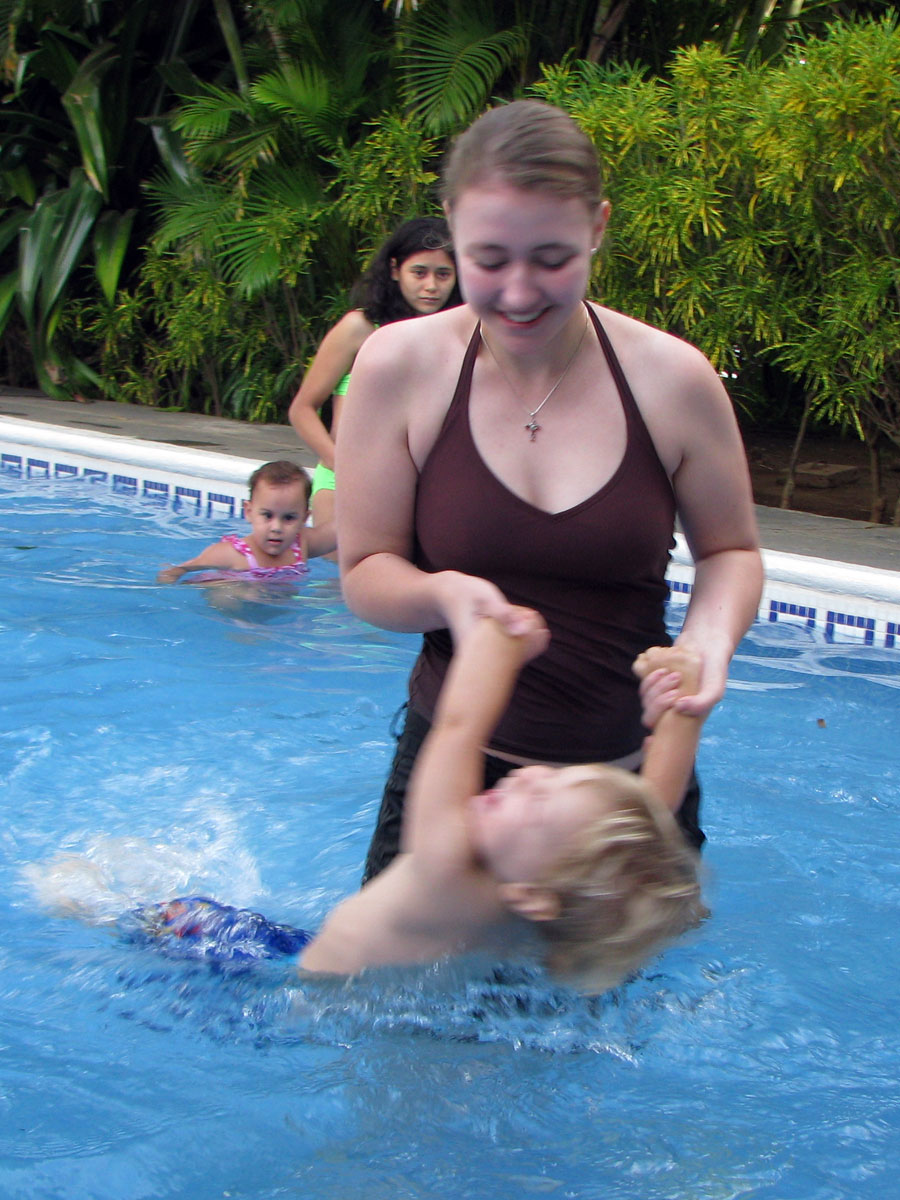 Abigail swings Josiah around in the little kids pool