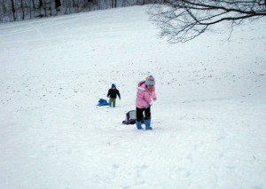 Analise and Josiah hike back up the hill after their first run