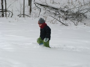 Josiah walks through the snow near the sledding hill