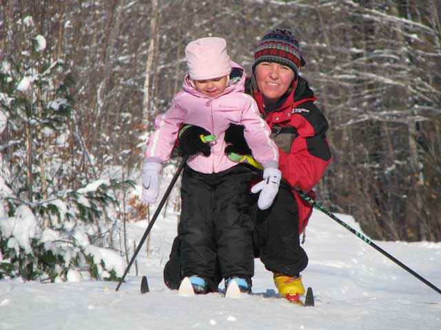 closeup of mother-daughter skiing